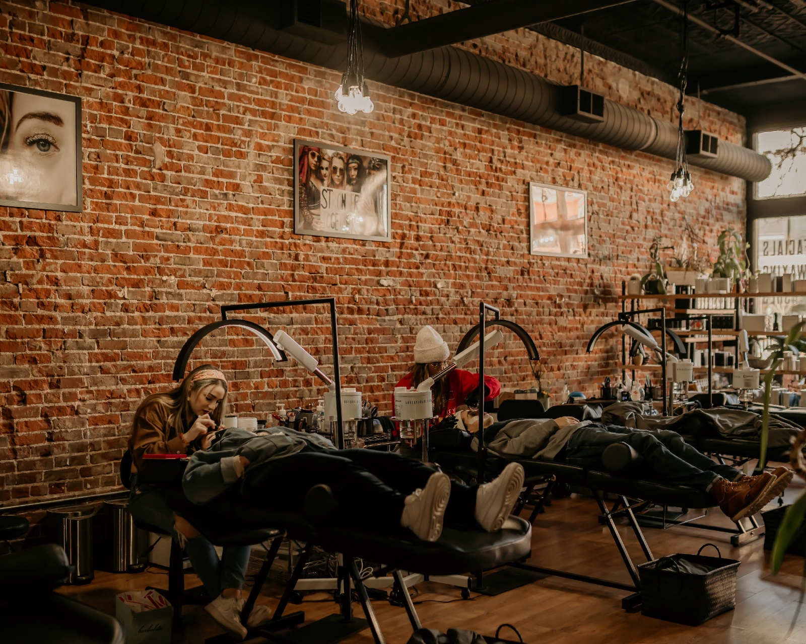 Brick building with customers laying down receiving eye lash services